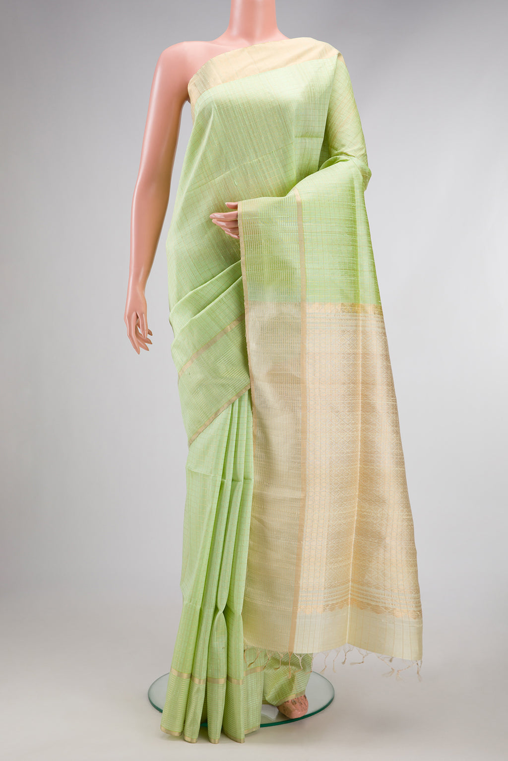 Pista Green Raw Silk Saree with Checked design on the body and Zari Border.  displayed on a mannequin