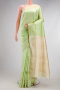 Pista Green Raw Silk Saree with Checked design on the body and Zari Border.  displayed on a mannequin