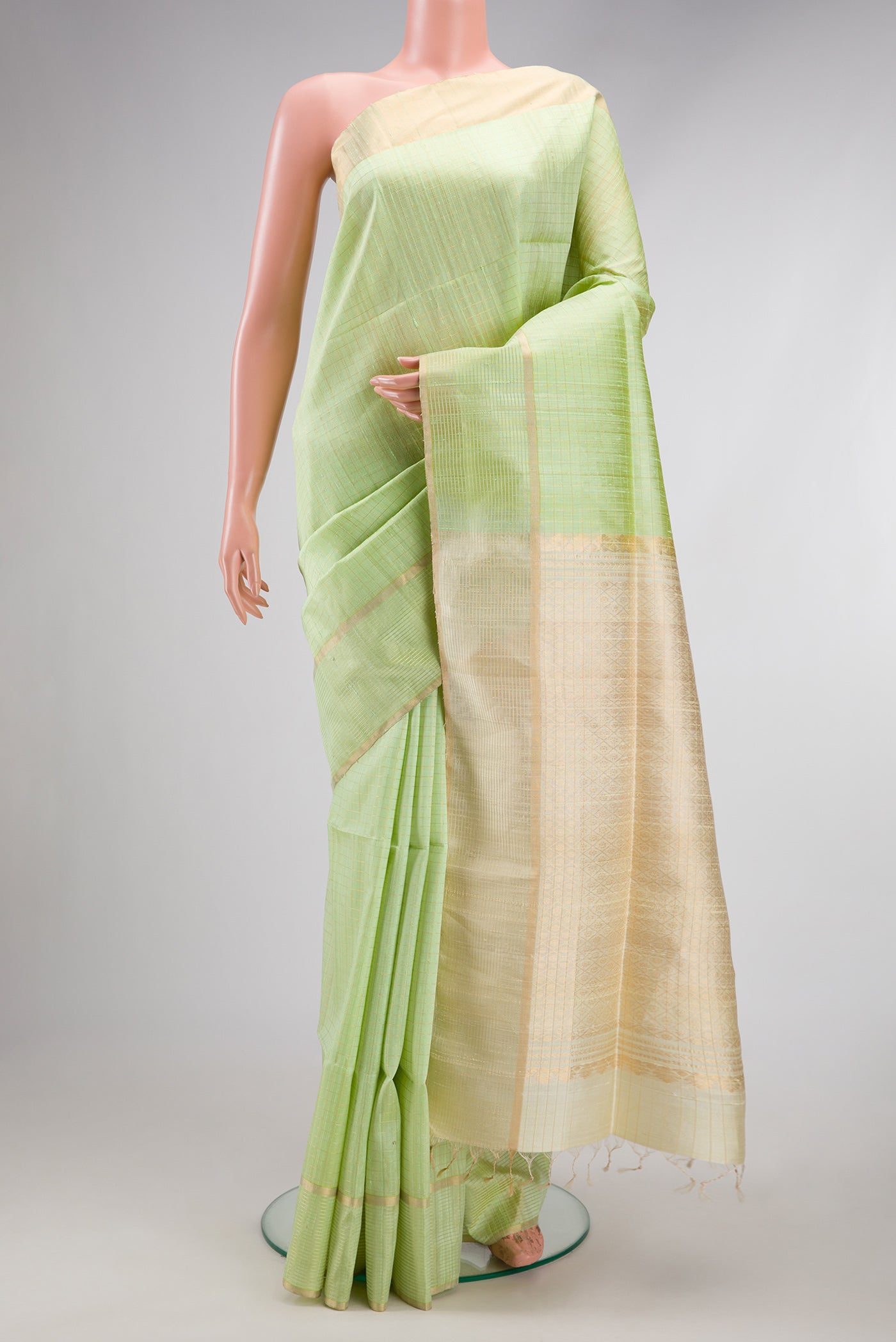 Pista Green Raw Silk Saree with Checked design on the body and Zari Border.  displayed on a mannequin