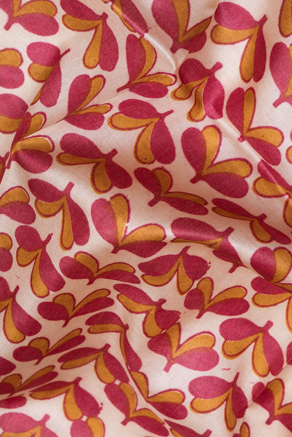 Close up of Beige Tussar Silk Saree with Printed design on the body and Zari Border.  displaying folds