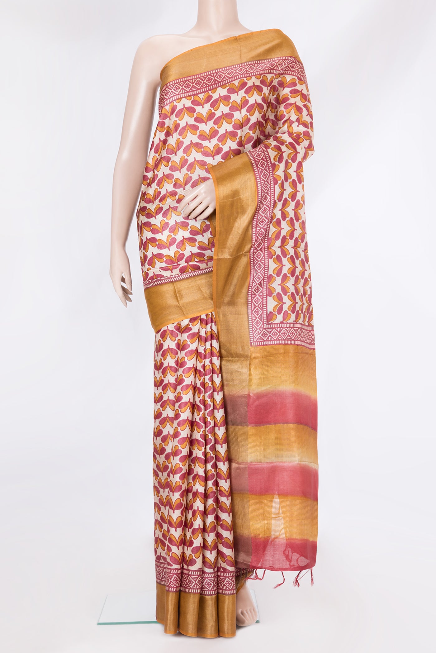 Beige Tussar Silk Saree with Printed design on the body and Zari Border.  displayed on a mannequin