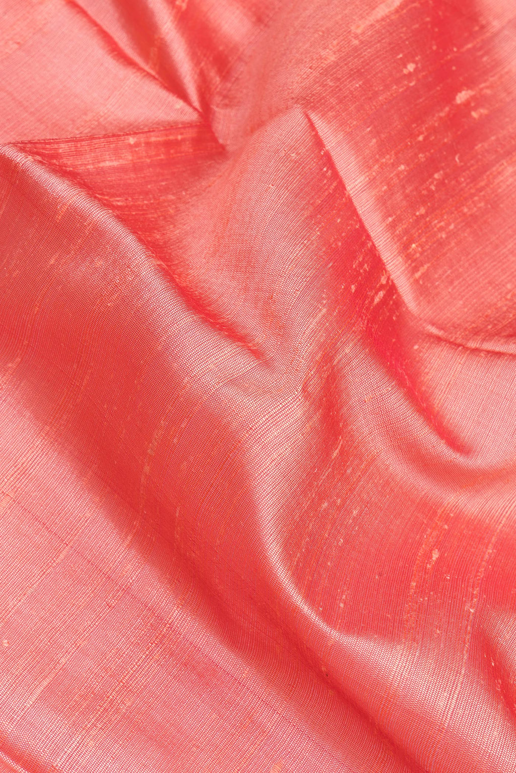 Close up of Coral Tussar Silk Saree with Plain Body and Zari Border.  displaying folds