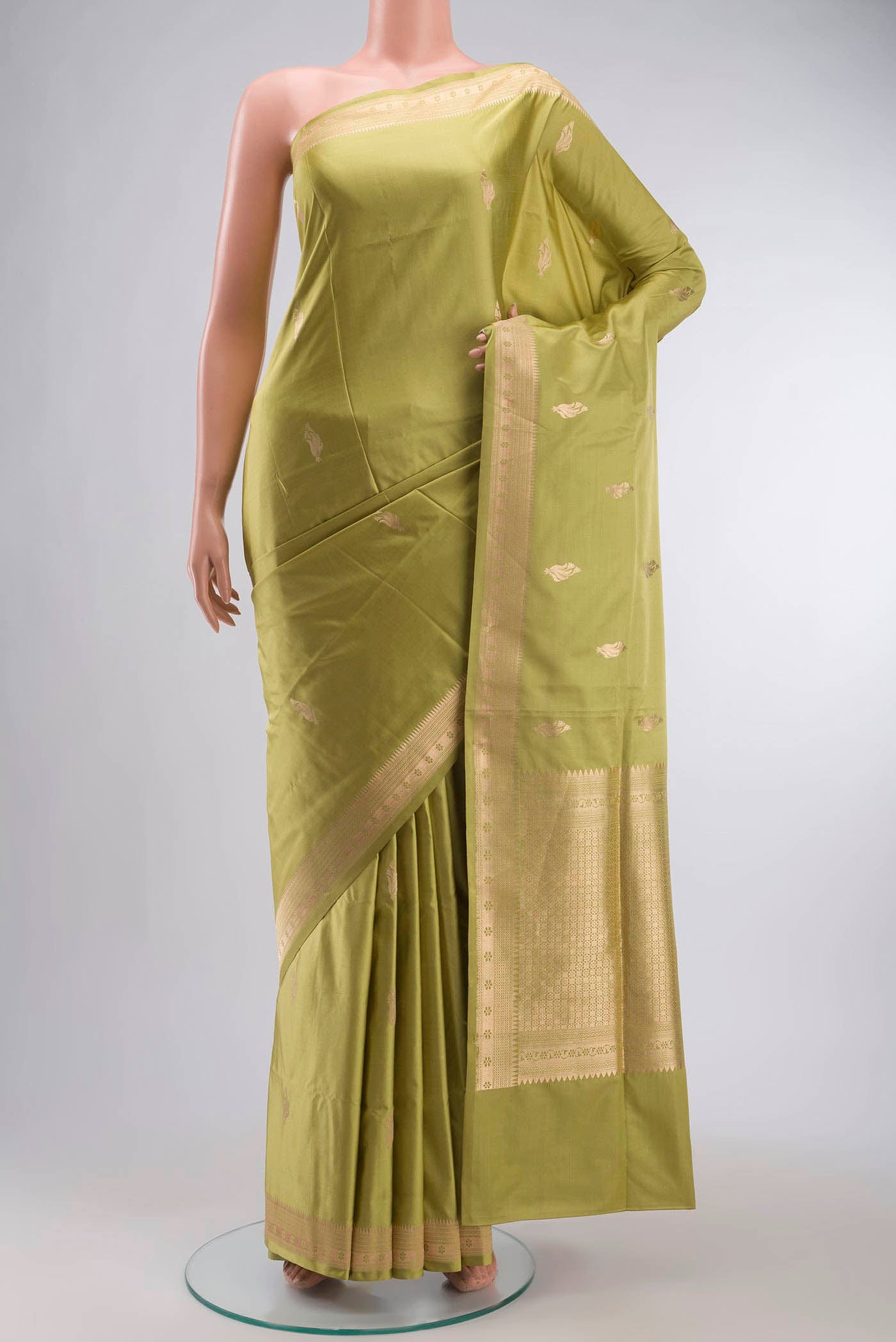 Green Banarasi Silk Saree with Zari Butta on the body and Zari Border displayed on a mannequin