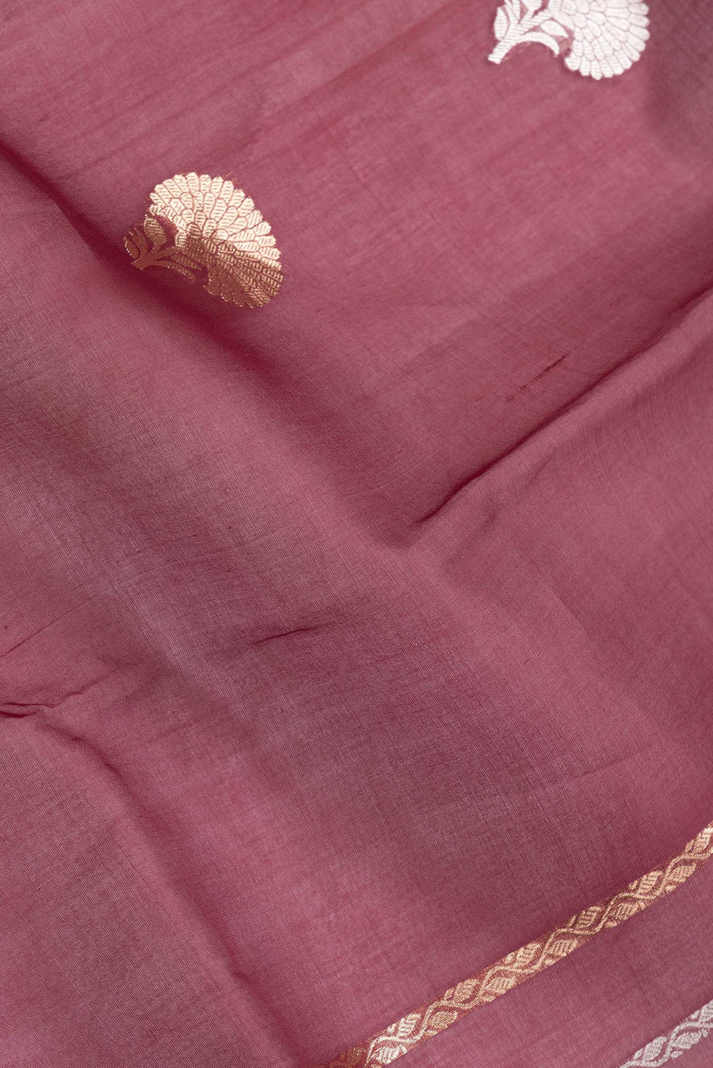 Close up of Maroon Dual Tone Organza Silk Saree with Zari Butta on the body and Thin Zari Line.  displaying folds