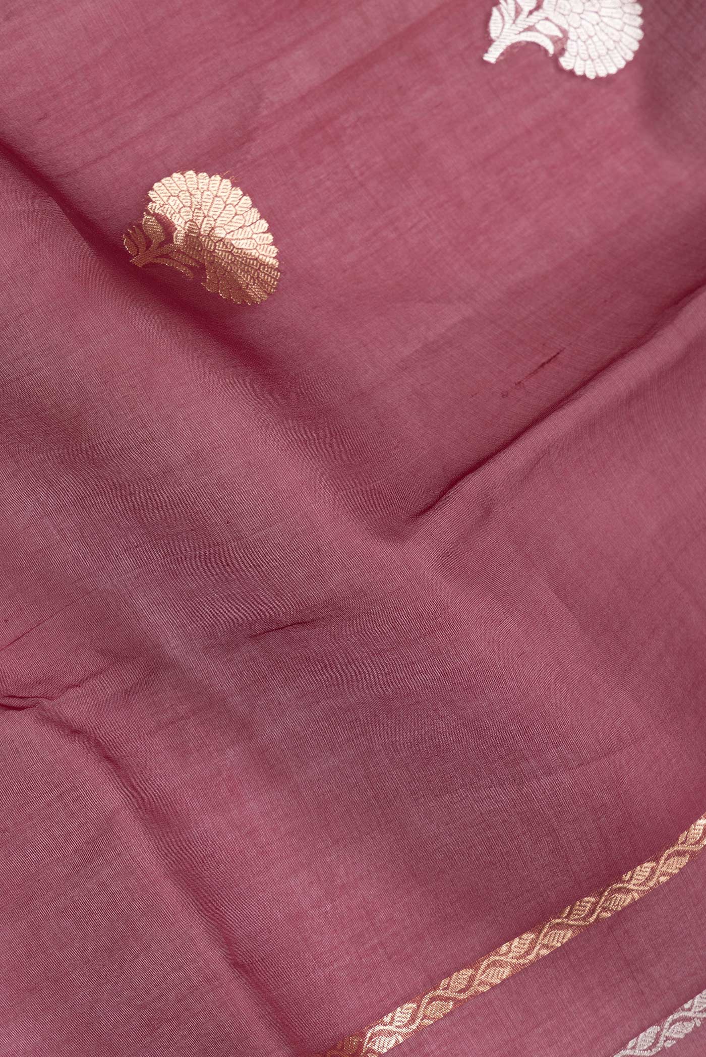 Close up of Maroon Dual Tone Organza Silk Saree with Zari Butta on the body and Thin Zari Line.  displaying folds