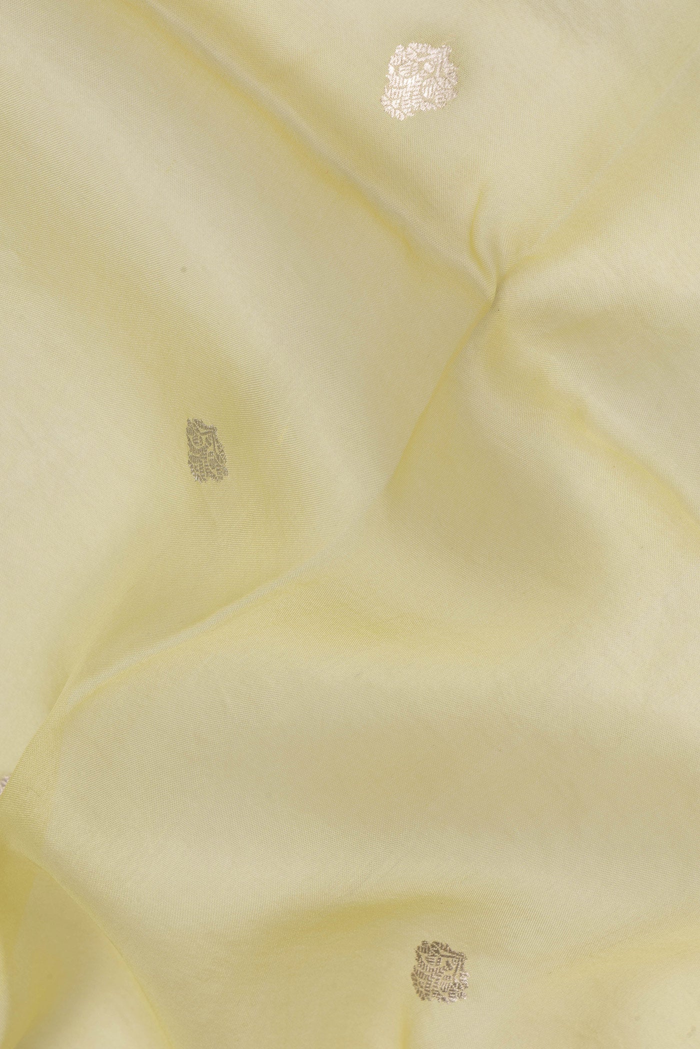 Close up of Pista Green Dual Tone Organza Silk Saree with Zari Brocade on the body and Zari Border.  displaying folds