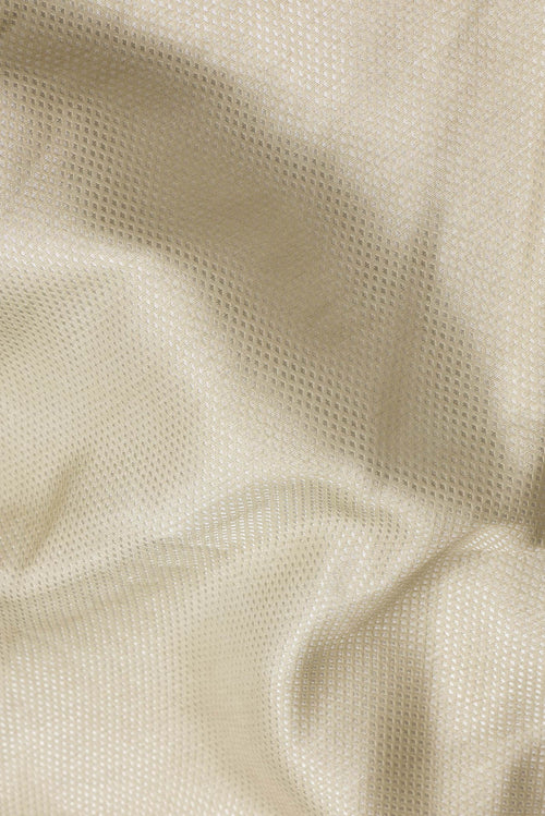 Close up of Beige Dual Tone Banarasi Silk Saree with Zari Brocade on the body and Embroidery Border.  displaying folds