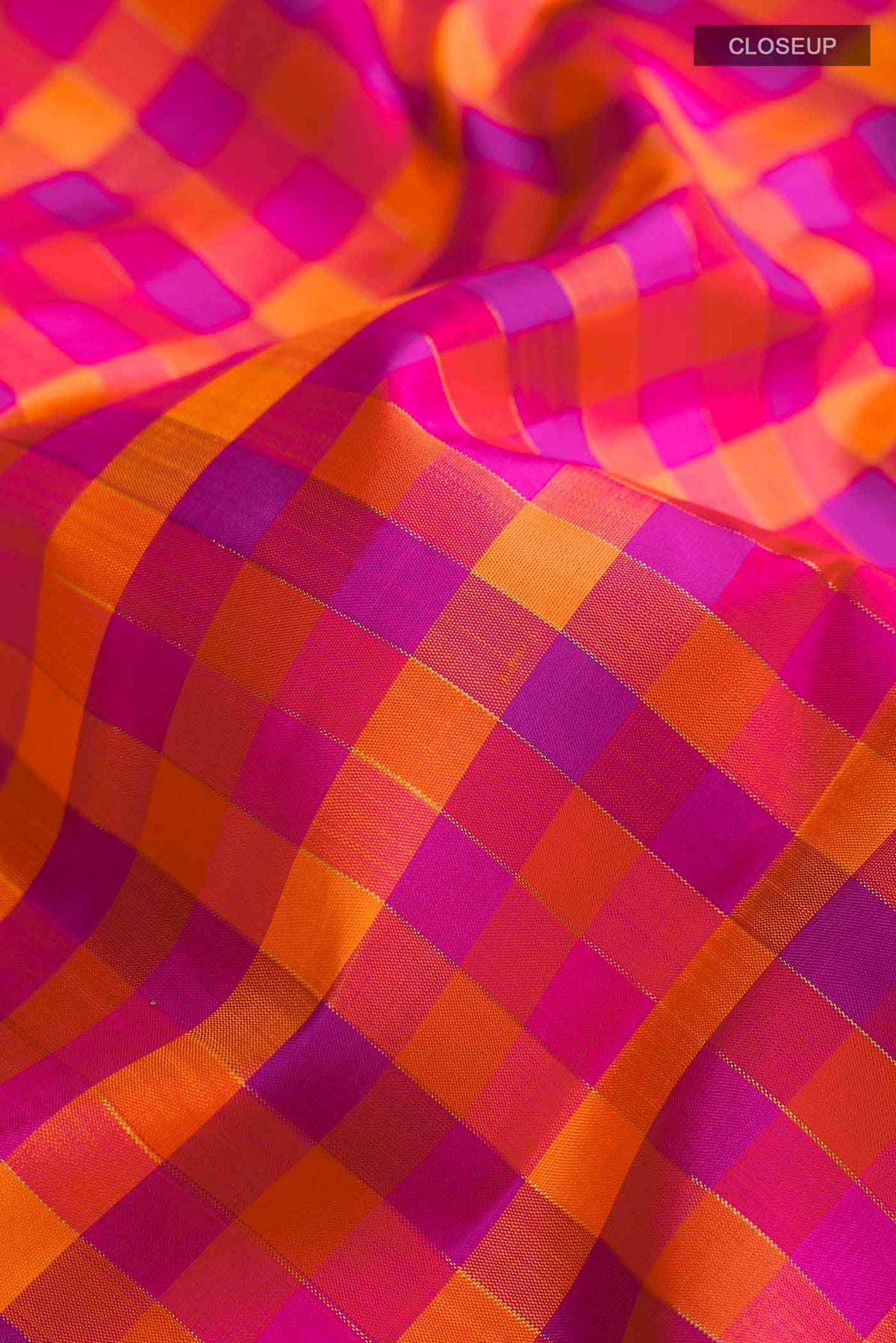 Close up of Multicolor Kanchipuram Silk Saree Checked design on the body and Zari Border displaying folds
