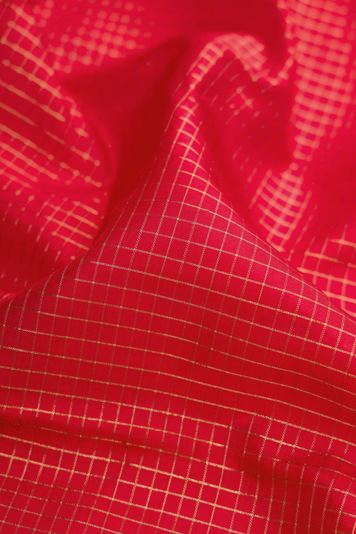 Close up of Pure Silk Pure Zari Red Dual Tone Kanchipuram Saree with Stripes on the body and Zari Border.  displaying folds