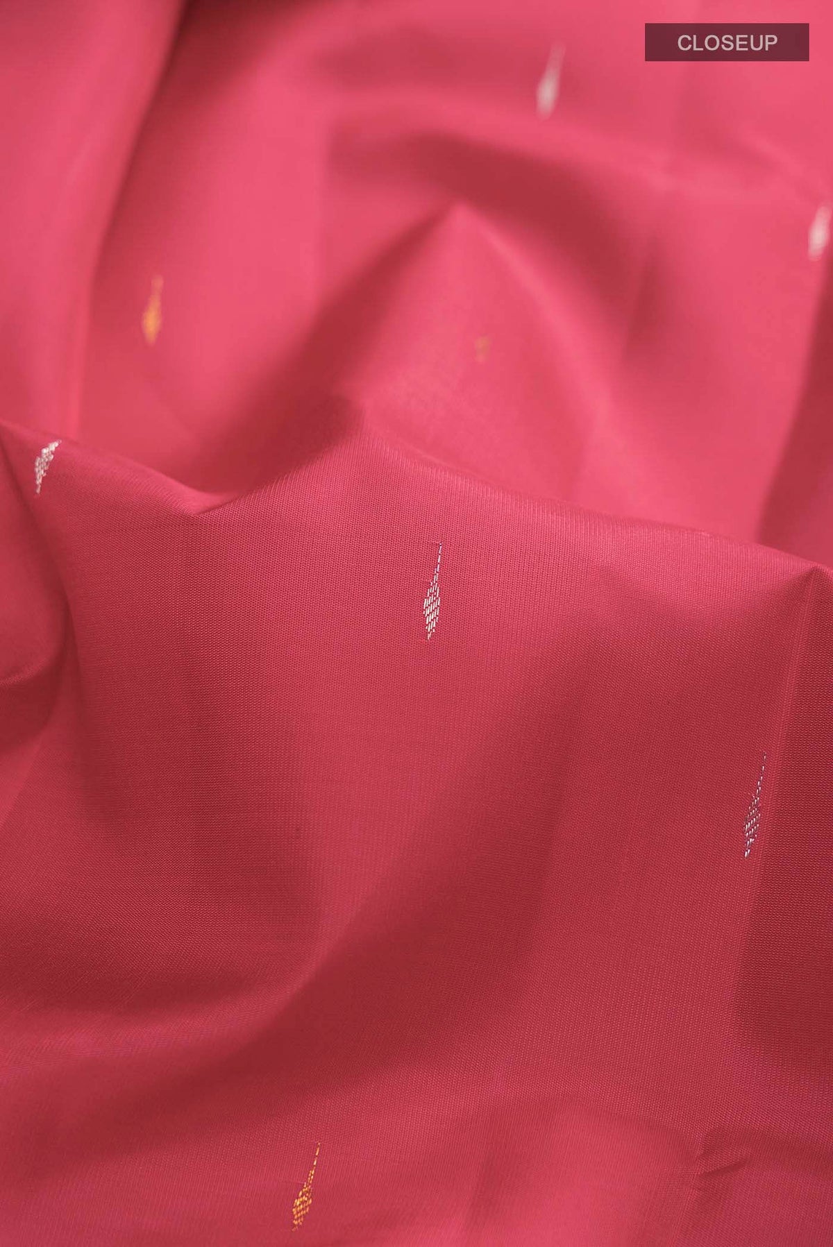 Close up of Red Kanchipuram Silk Saree with Zari Butta on the body and Zari Border displaying folds