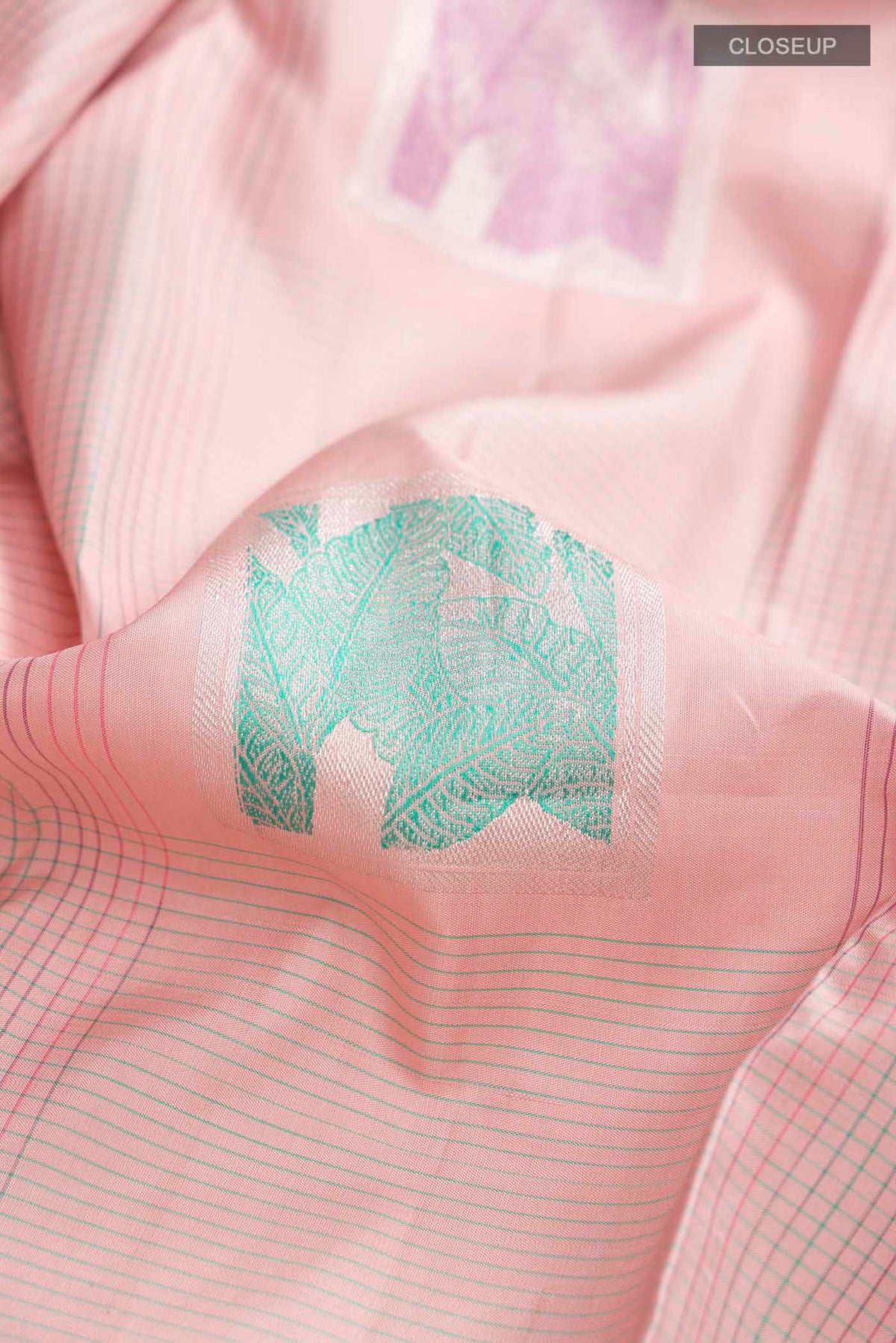 Close up of Rose pink Kanchipuram Silk Saree with Stripes on the body and Plain Border displaying folds