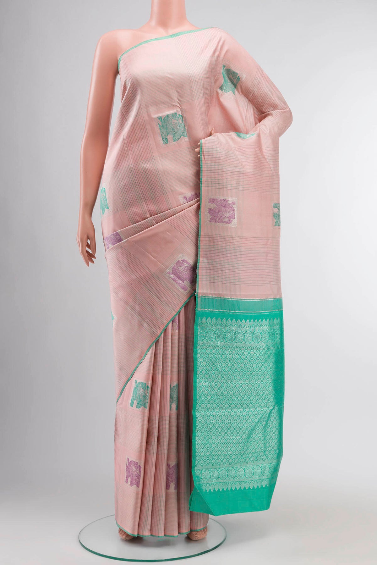 Rose pink Kanchipuram Silk Saree with Stripes on the body and Plain Border displayed on a mannequin