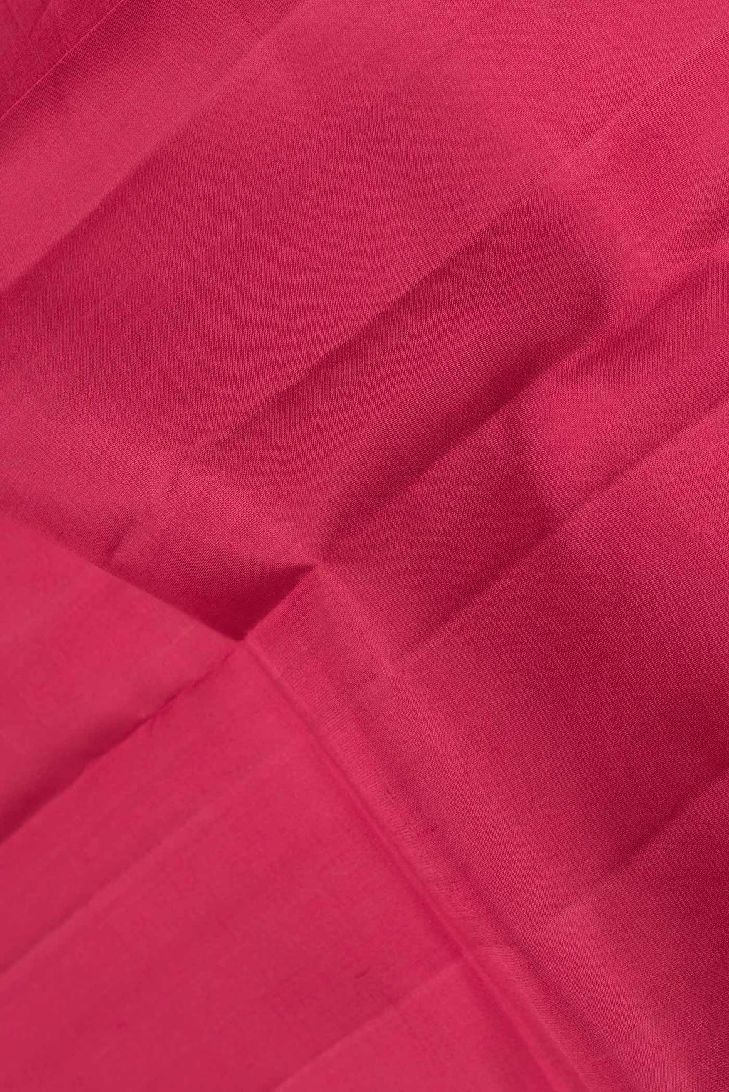 Close up of Maroon Dual Tone Kanjivaram Saree with Plain Body and Zari Border.  displaying folds