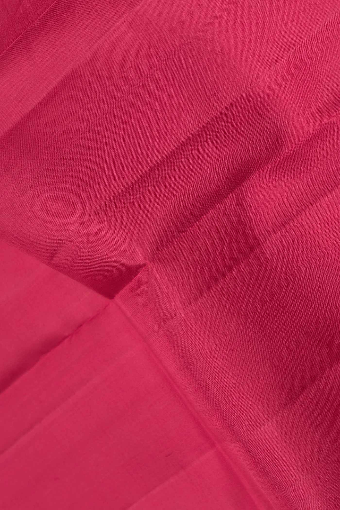 Close up of Maroon Dual Tone Kanjivaram Saree with Plain Body and Zari Border.  displaying folds