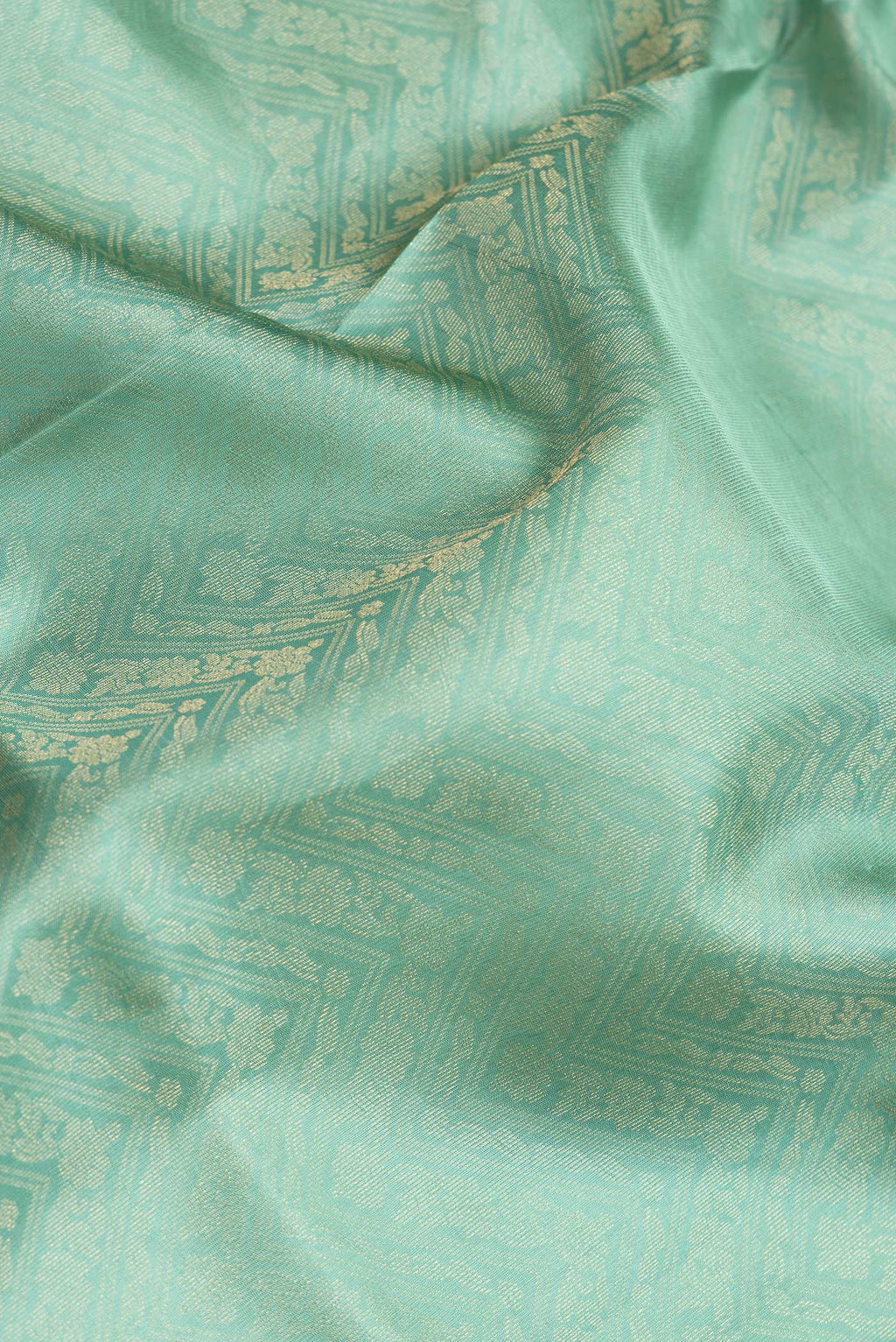 Close up of Sea Green Dual Tone Soft Silk Saree with Zari Brocade on the body and Zari Border.  displaying folds