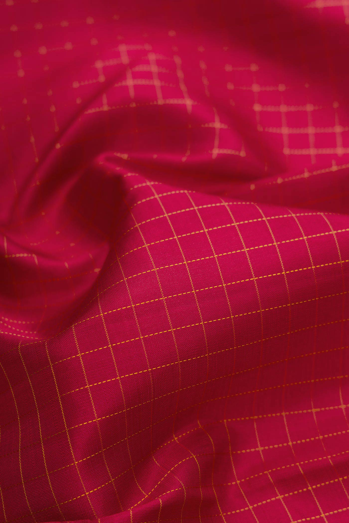 Close up of Maroon Dual Tone Kanchipuram Silk Saree with Checked design on the body and Zari Border.  displaying folds