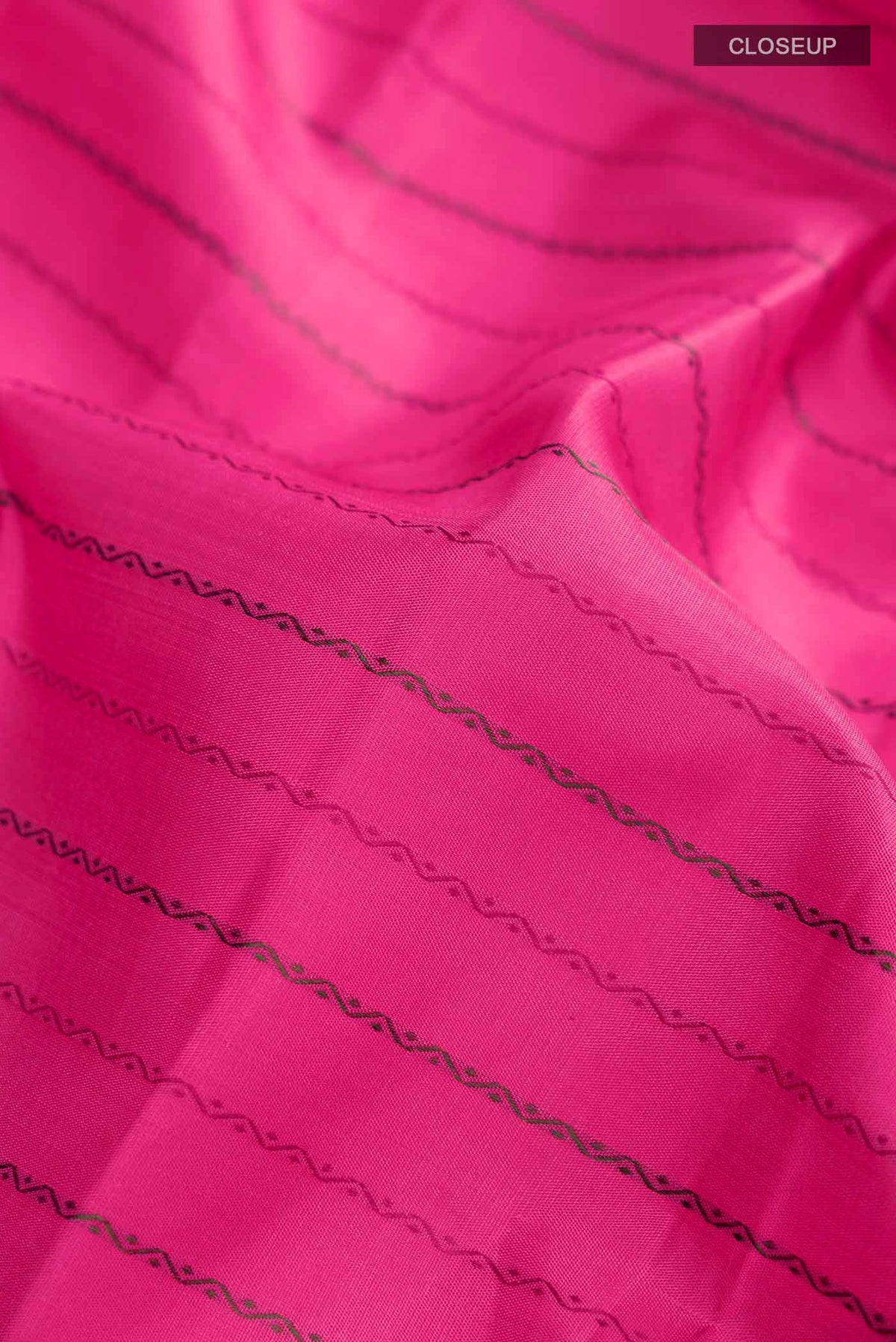 Close up of Pink Kanchipuram Silk Saree with Stripes on the body and Zari Border displaying folds