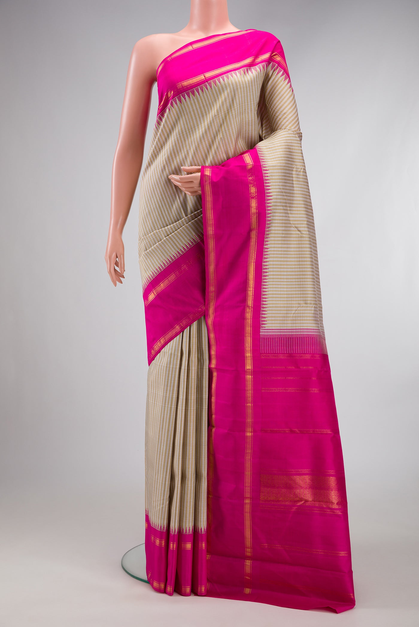 Beige Kanchipuram Silk Saree with Checked design on the body and Zari Border.  displayed on a mannequin