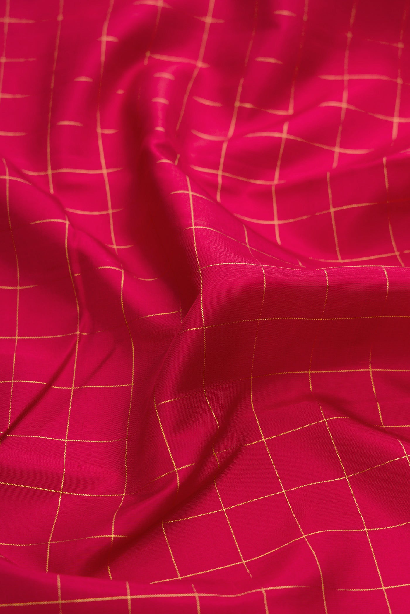 Close up of Maroon Kanchipuram Silk Saree with Checked design on the body and Fancy Border.  displaying folds