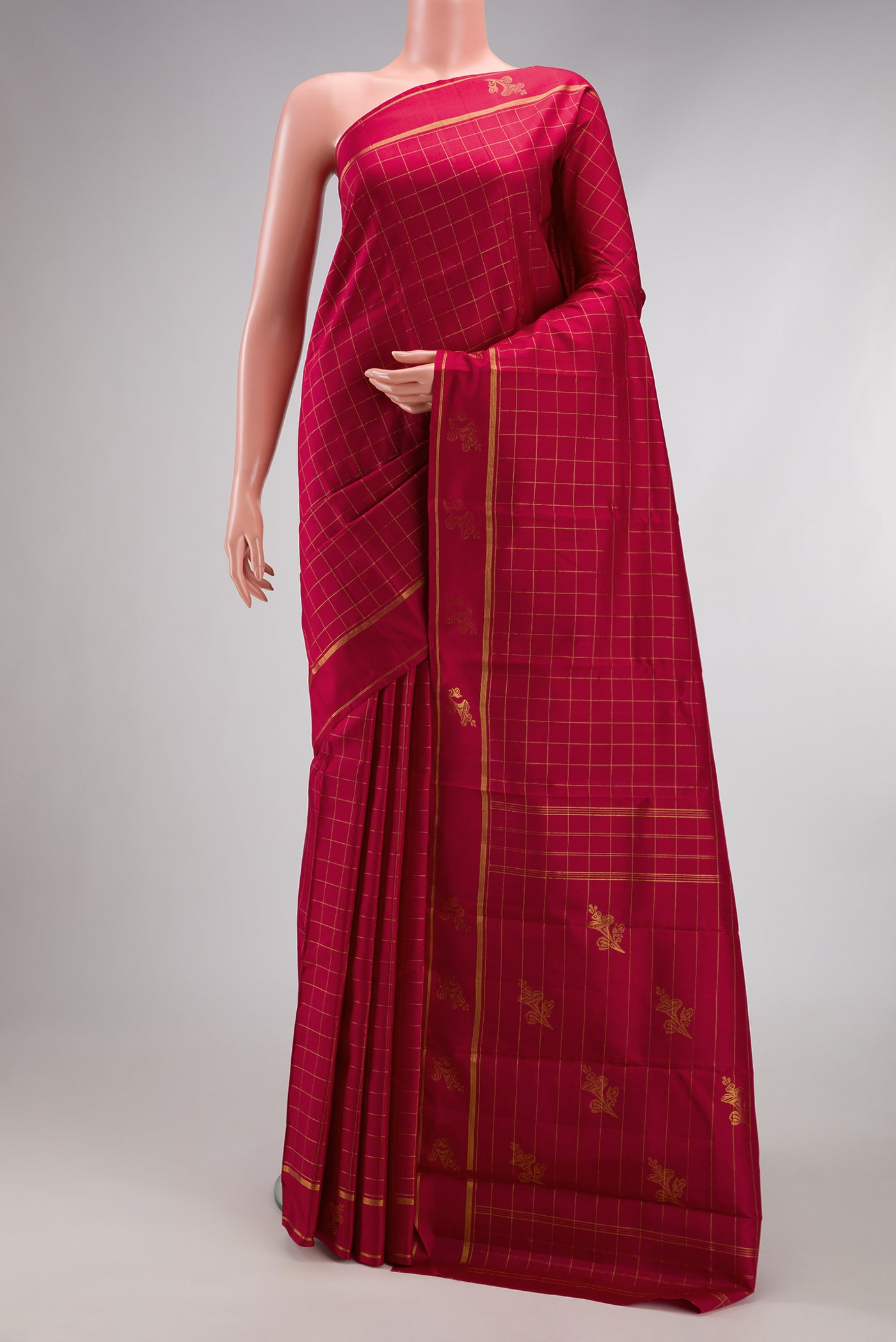 Maroon Kanchipuram Silk Saree with Checked design on the body and Fancy Border.  displayed on a mannequin