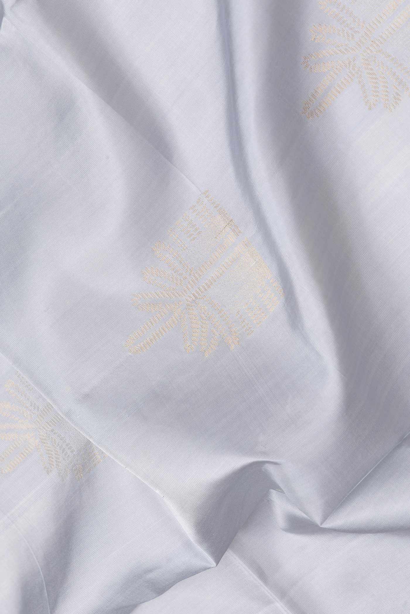 Close up of Grey Dual Tone Soft Silk Saree with Zari Butta on the body and Zari Border.  displaying folds