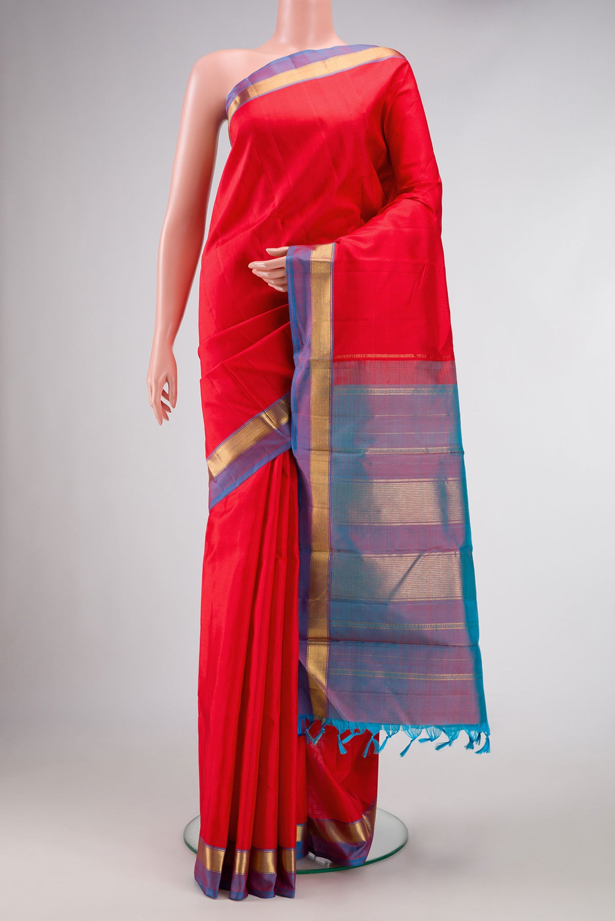 Red Dual Tone Kanjivaram Silk Saree with Plain Body and Zari Border.  displayed on a mannequin