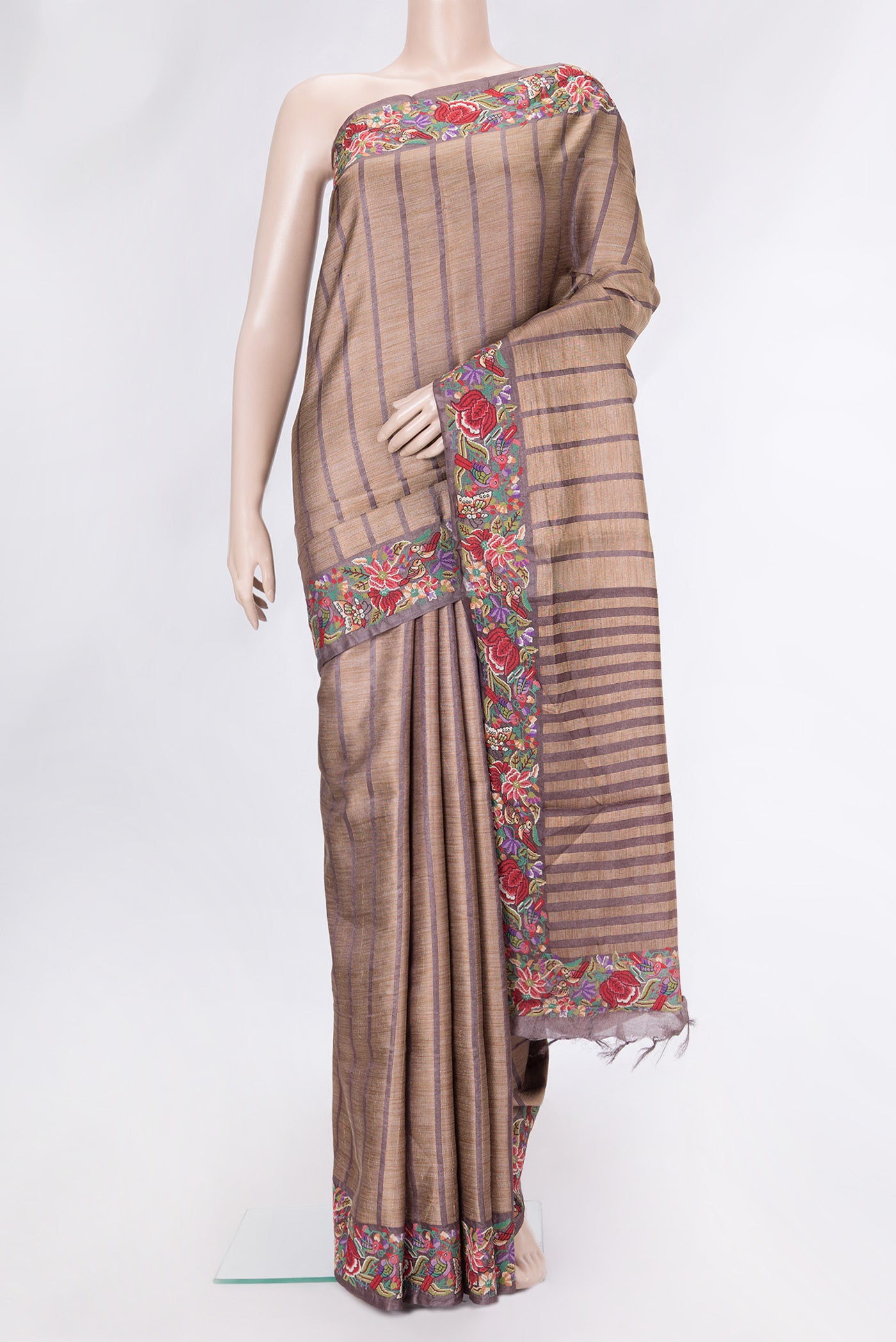Brown Dual Tone Tussar Silk Saree with Stripes on the body and Embroidery Border.  displayed on a mannequin