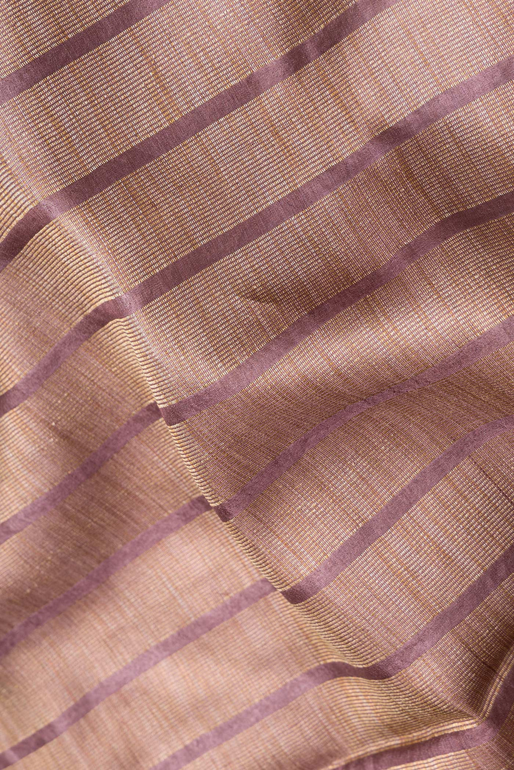 Close up of Maroon Dual Tone Tussar Silk Saree with Stripes on the body and Embroidery Border.  displaying folds