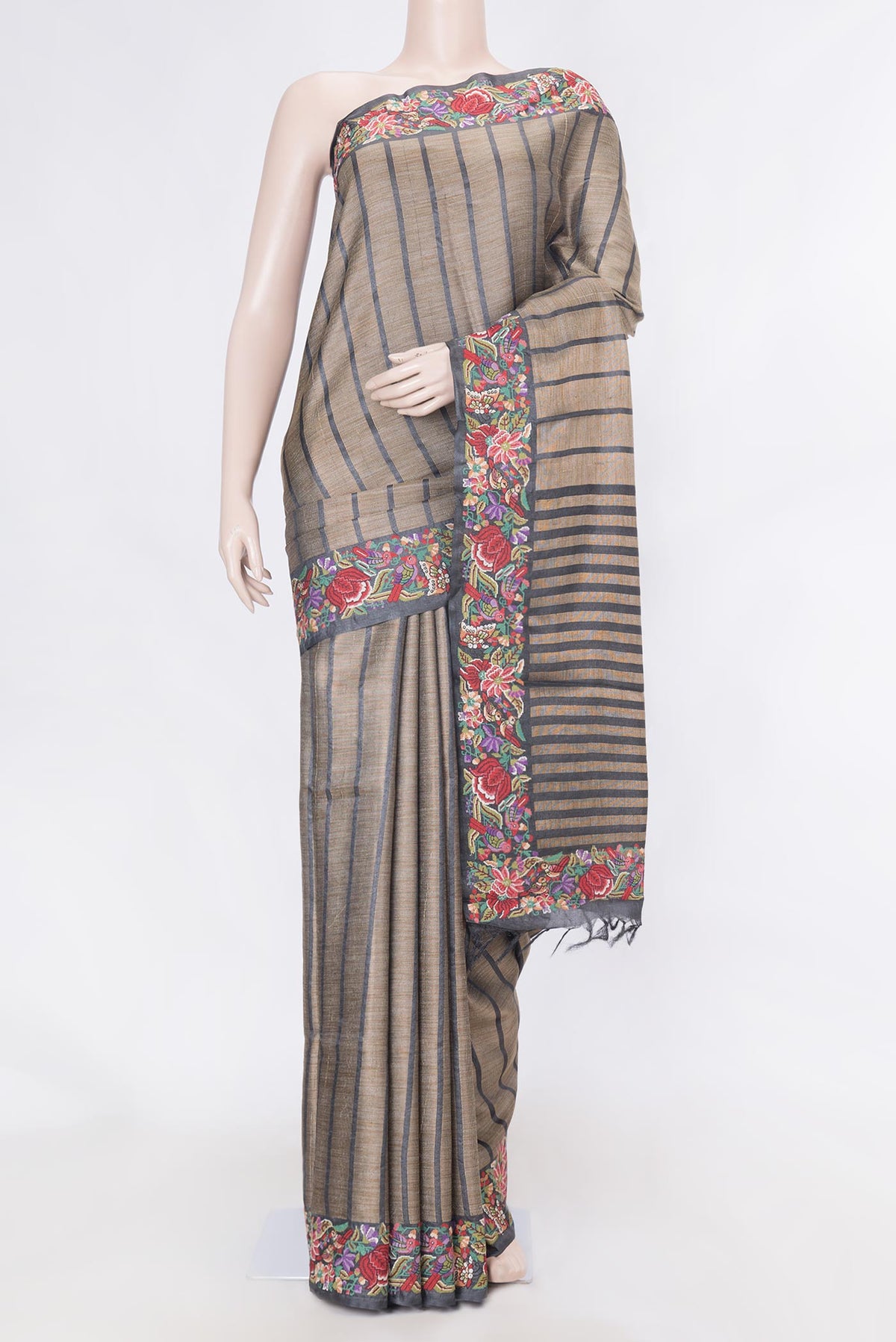 Black Dual Tone Tussar Silk Saree with Stripes on the body and Embroidery Border displayed on a mannequin