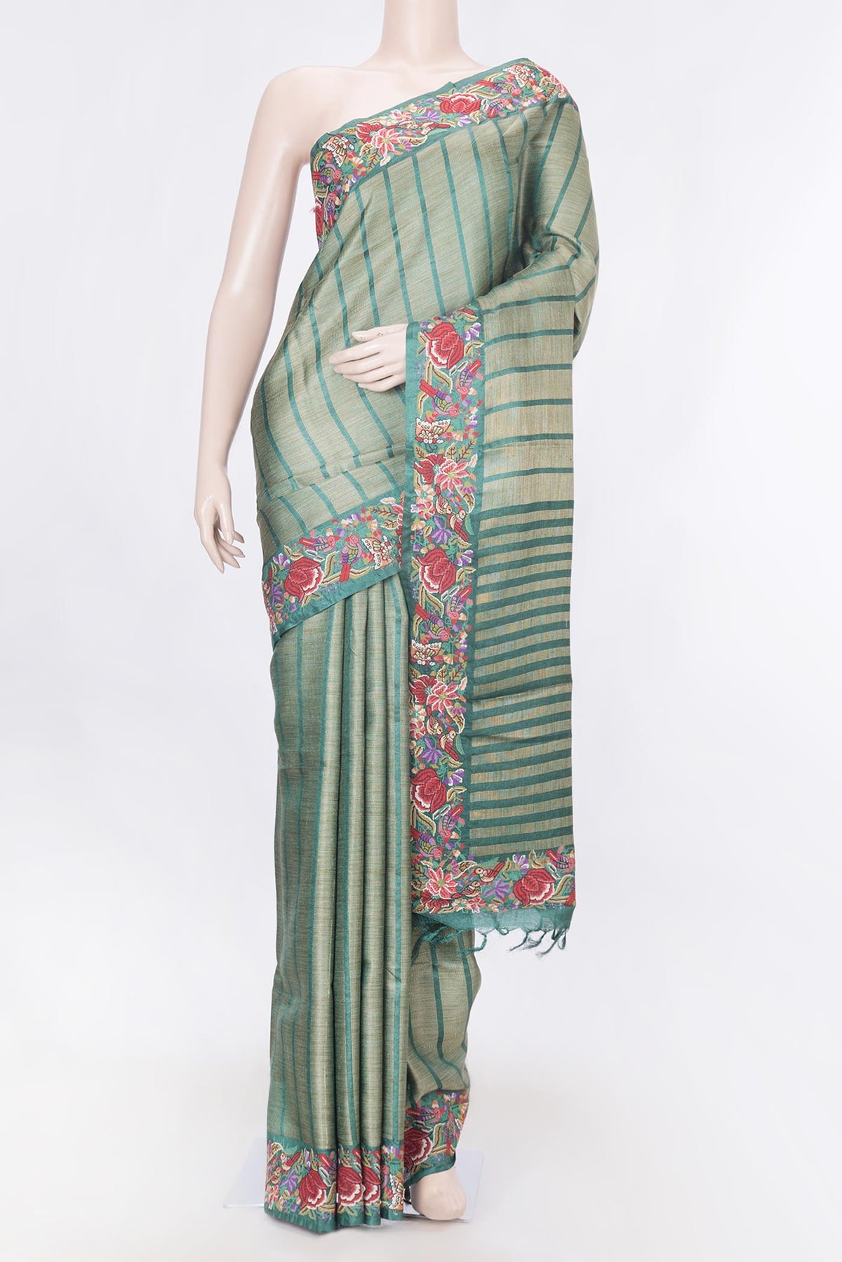 Green Dual Tone Tussar Silk Saree with Stripes on the body and Embroidery Border displayed on a mannequin