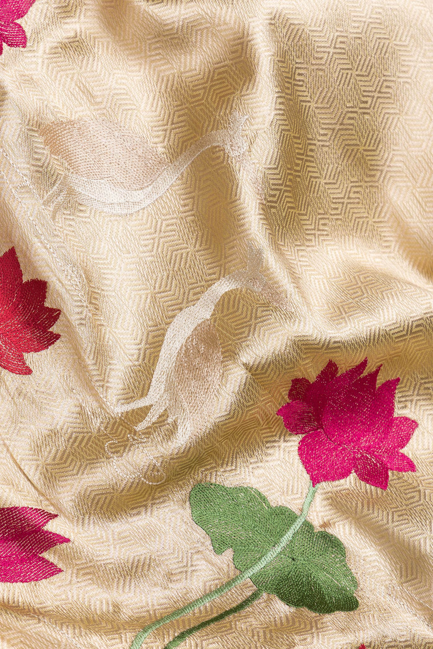 Close up of Gold Dual Tone Organza Silk Saree with Zari Brocade on the body and Fancy Border.  displaying folds