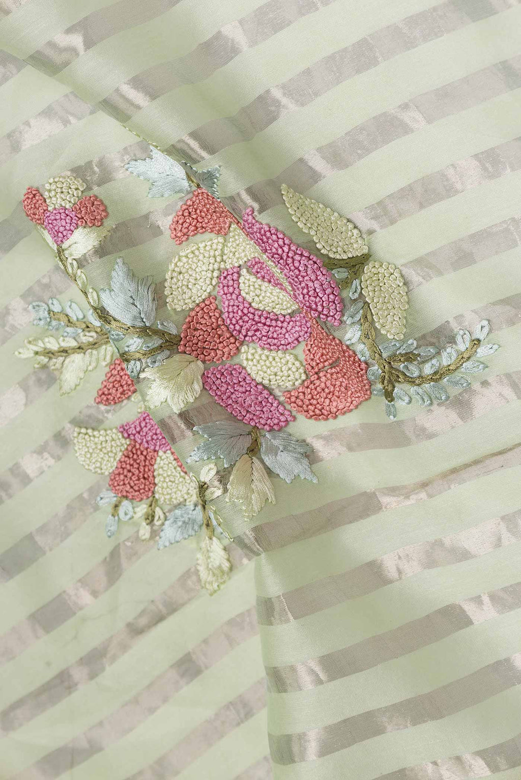 Close up of Pista Green Tussar Silk Saree with Stripes on the body and Embroidery Border displaying folds