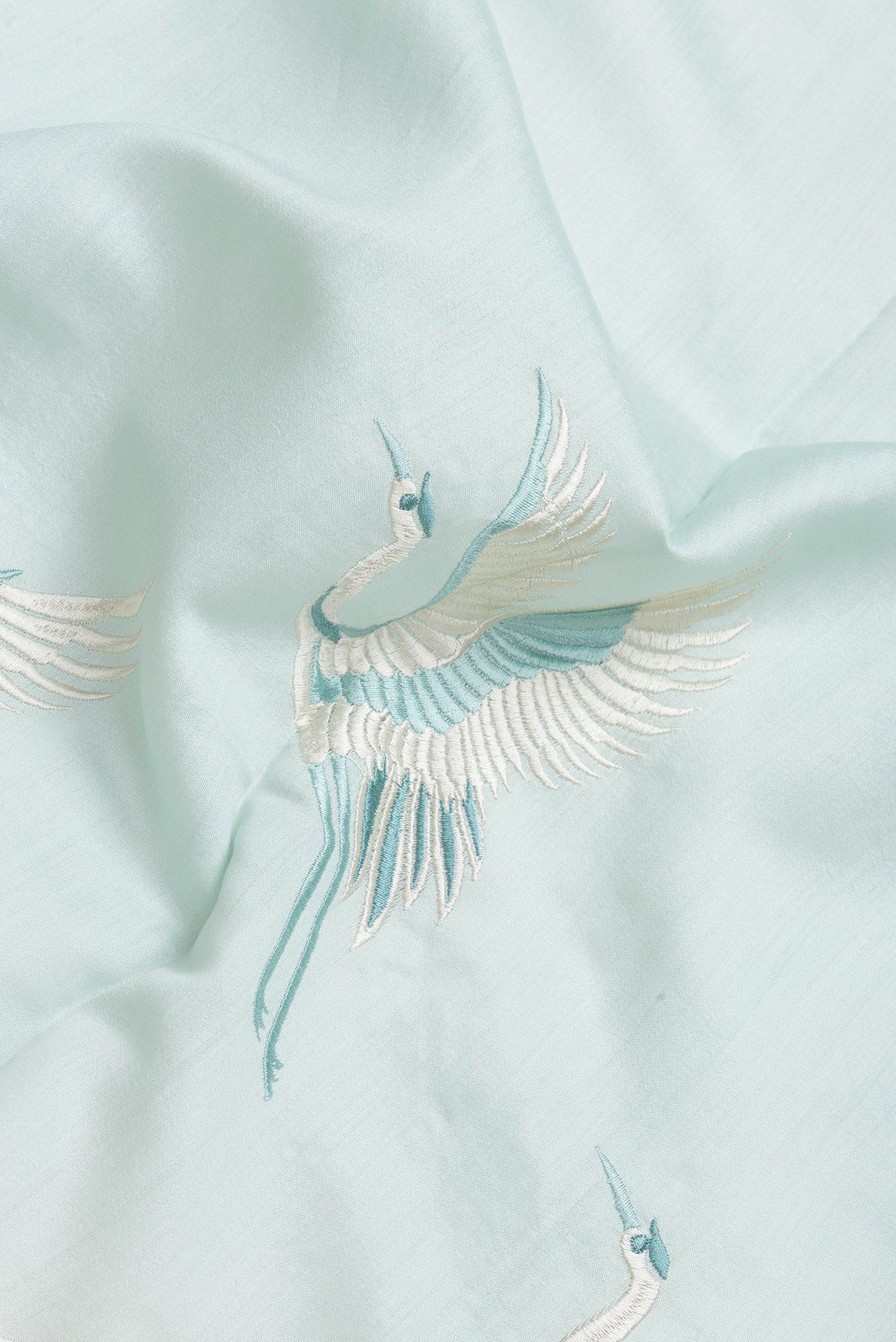 Close up of Light Blue Dual Tone Tussar Silk Saree with Plain Body and Fancy Border.  displaying folds