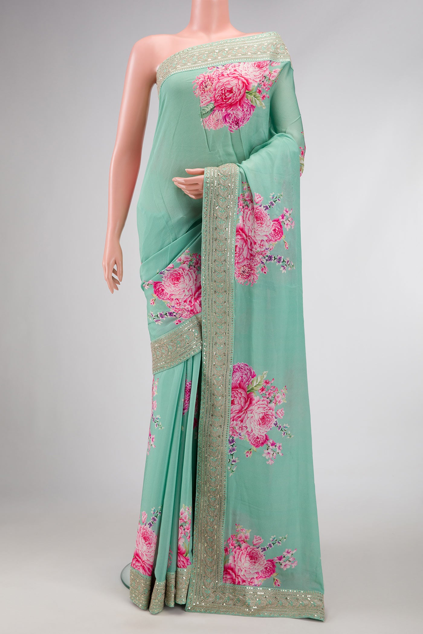 Pista Green Dual Tone Mysore Georgette Saree with Printed design on the body and Embroidery Border.  displayed on a mannequin