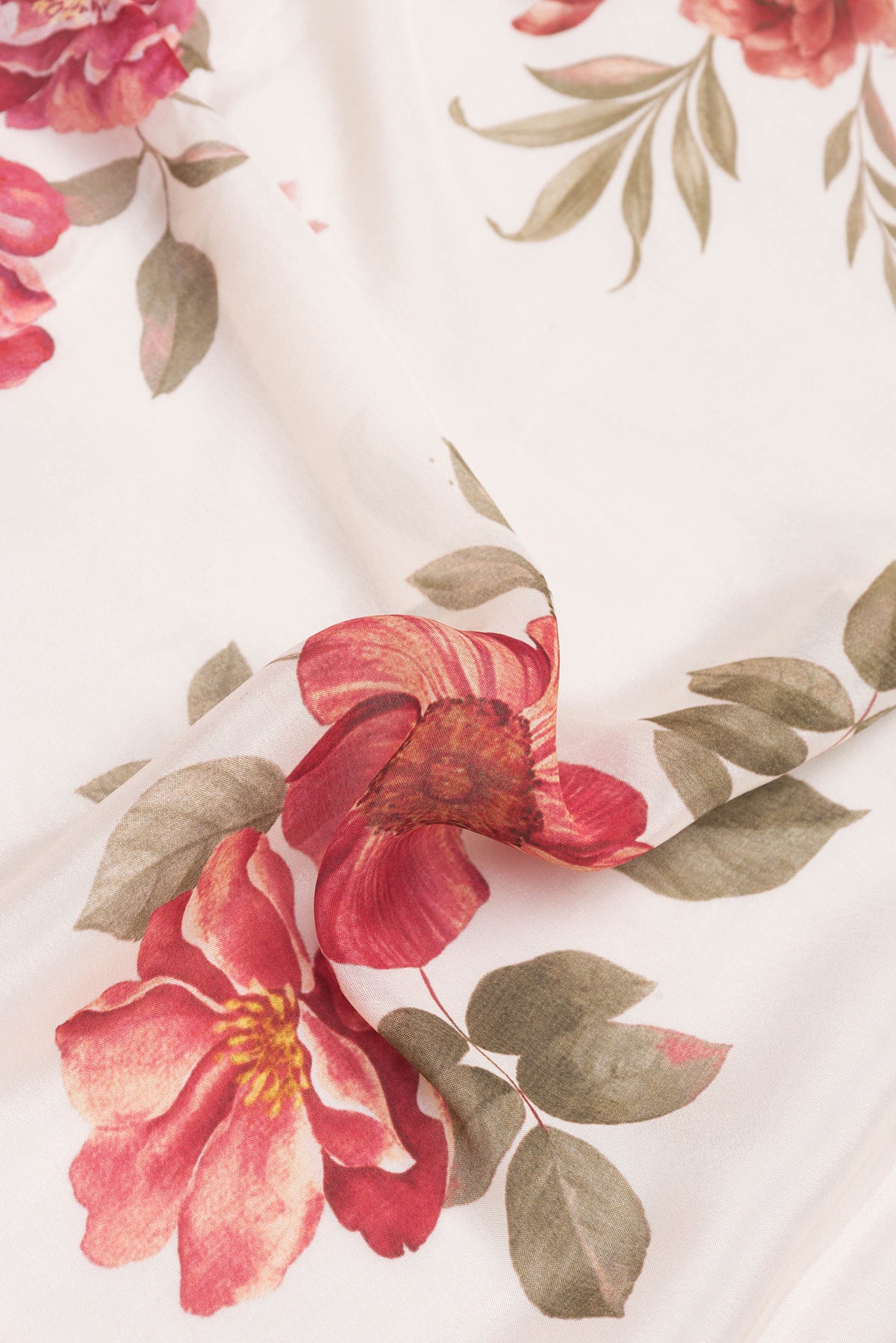Close up of Golden Peach Dual Tone Georgette Saree with Printed design on the body and Embroidery Border.  displaying folds