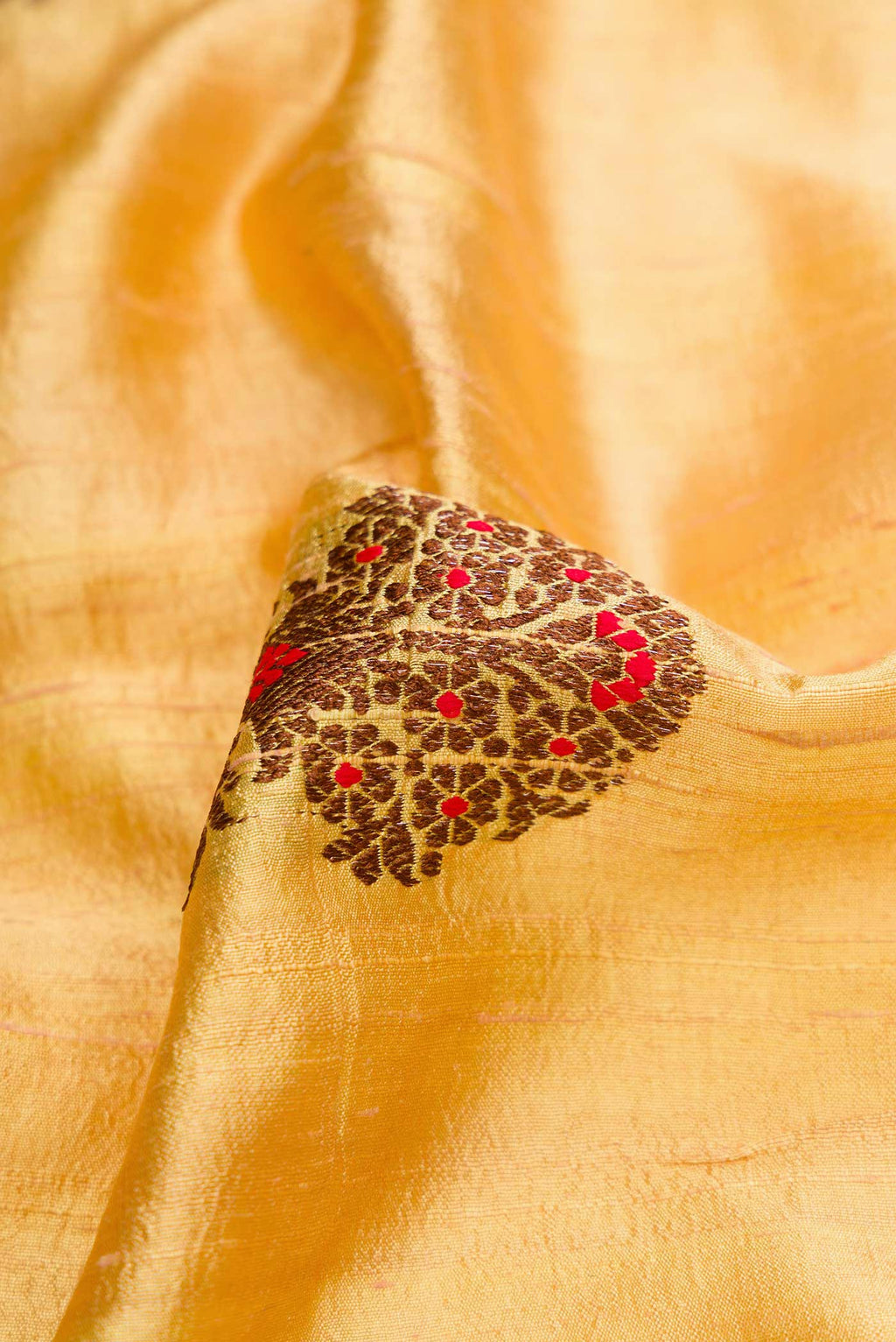 Close up of Sandal Banarasi Tussar Silk Saree with Zari And Thread Butta on the body and Without Border displaying folds