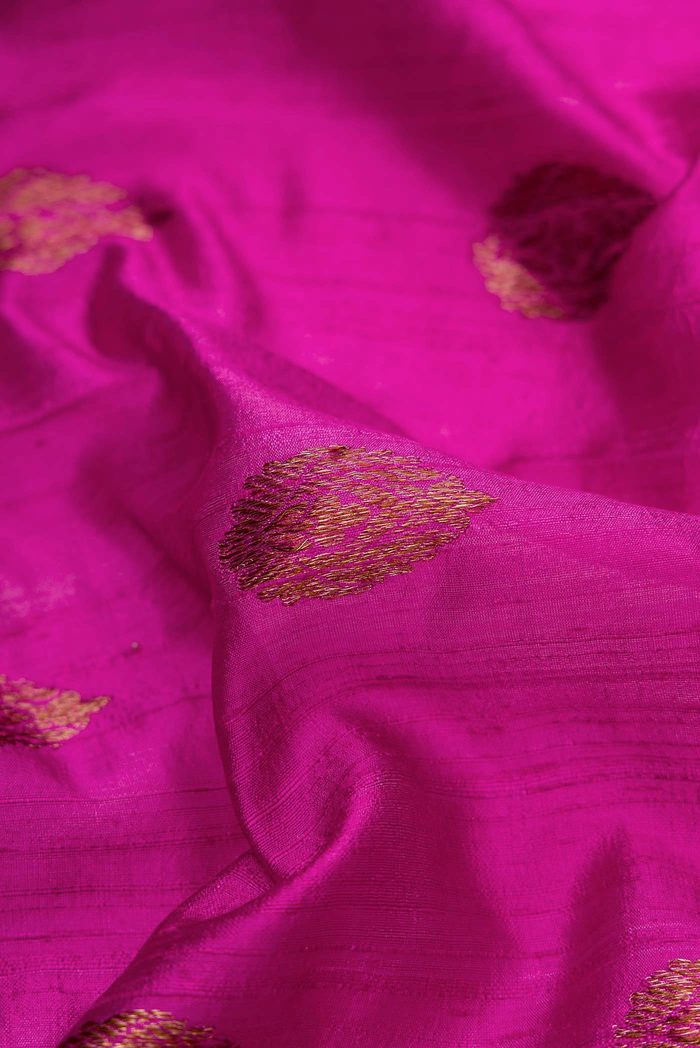 Close up of Magenta Dual Tone Raw Silk Saree with Zari Butta on the body and Zari Border displaying folds