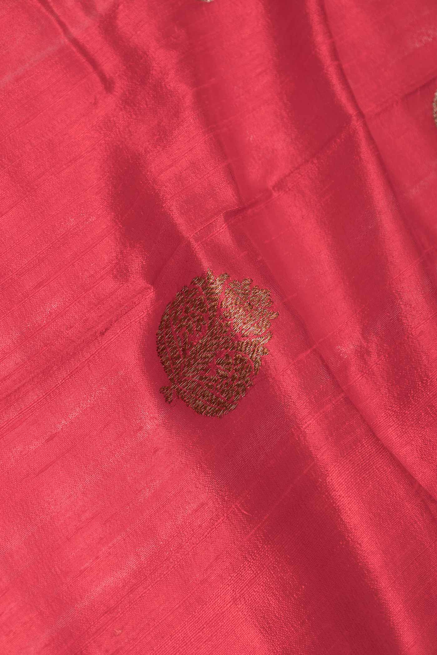 Close up of Red Dual Tone Raw Silk Saree with Zari Butta on the body and Zari Border displaying folds