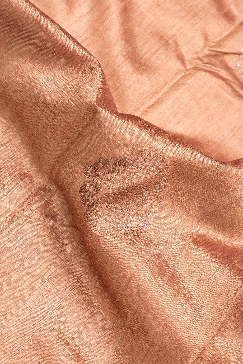 Close up of Brown Dual Tone Raw Silk Saree with Zari Butta on the body and Zari Border.  displaying folds