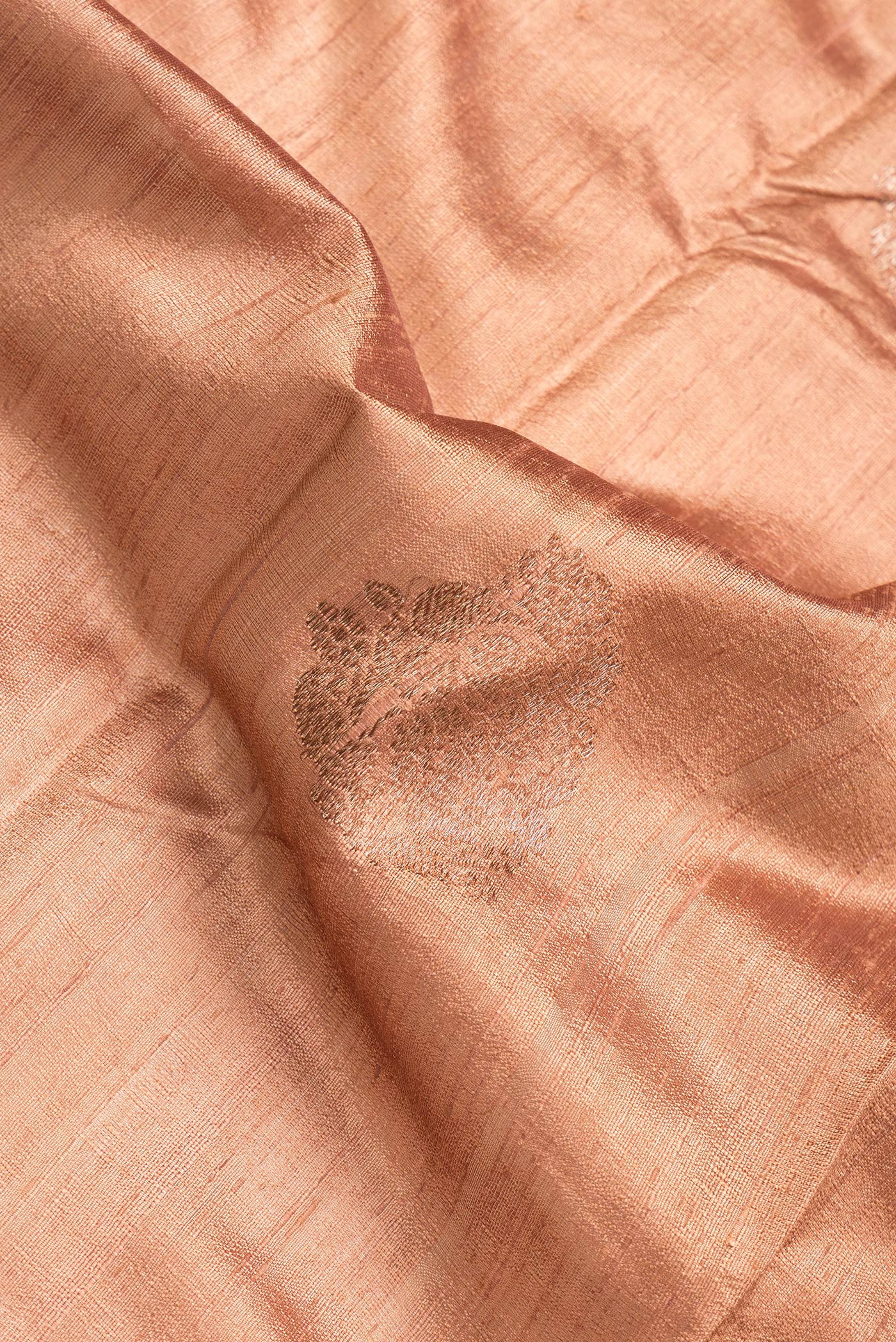 Close up of Brown Dual Tone Raw Silk Saree with Zari Butta on the body and Zari Border.  displaying folds