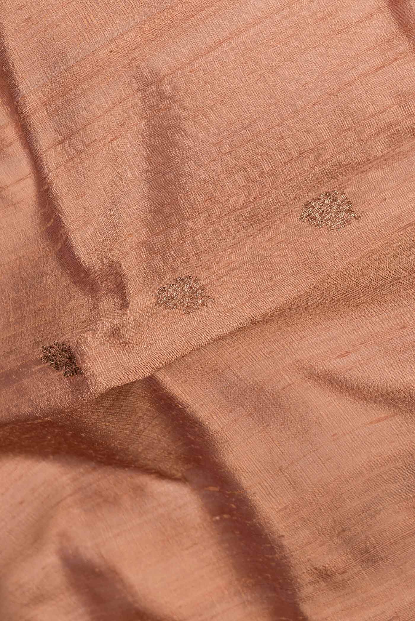 Close up of Brown Dual Tone Tussar Saree with Zari Butta on the body and Zari And Thread Border.  displaying folds