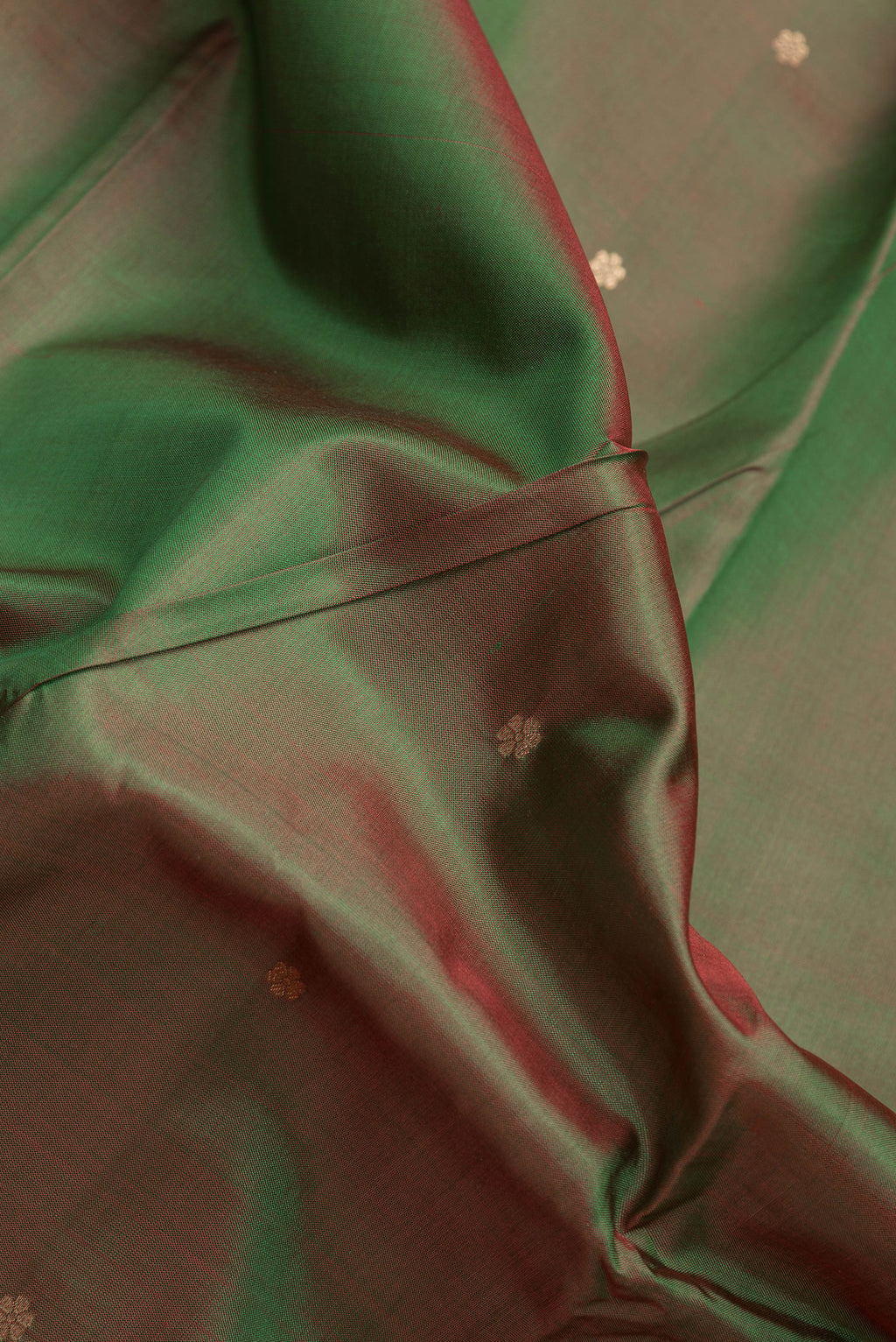 Close up of Mehandi Green Dual Tone Banarasi Silk Saree with Zari Butta on the body and Zari Border.  displaying folds