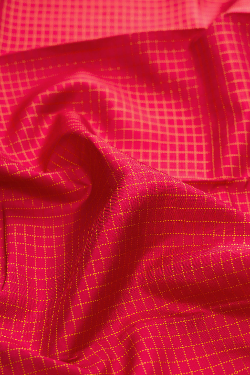 Close up of Maroon Kanchipuram Silk Saree with Checked design on the body and Zari Border.  displaying folds