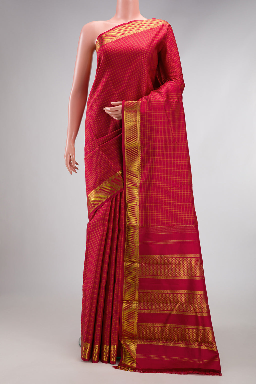 Maroon Kanchipuram Silk Saree with Checked design on the body and Zari Border.  displayed on a mannequin