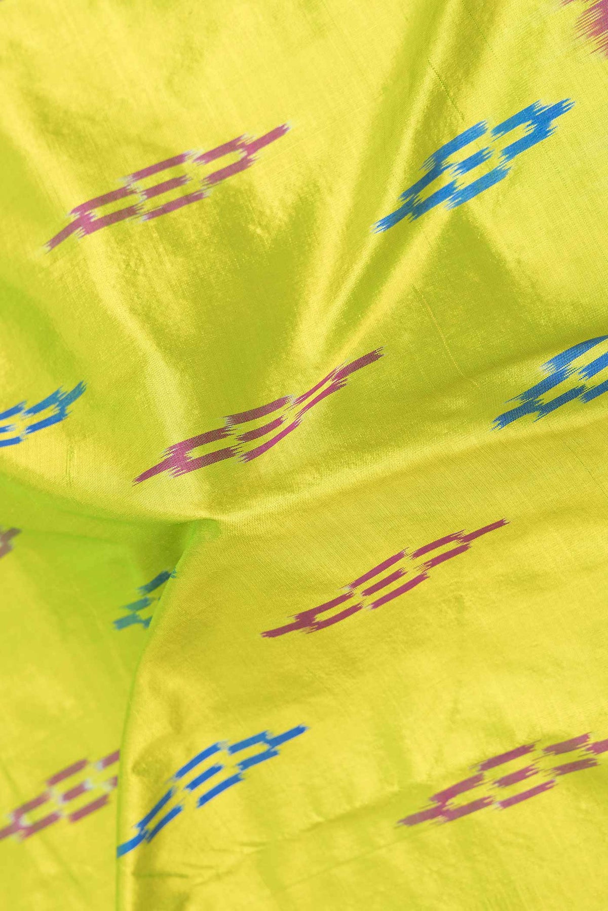Close up of Parrot Green Dual Tone Double Ikat Saree with Ikat Print on the body and Zari Border displaying folds