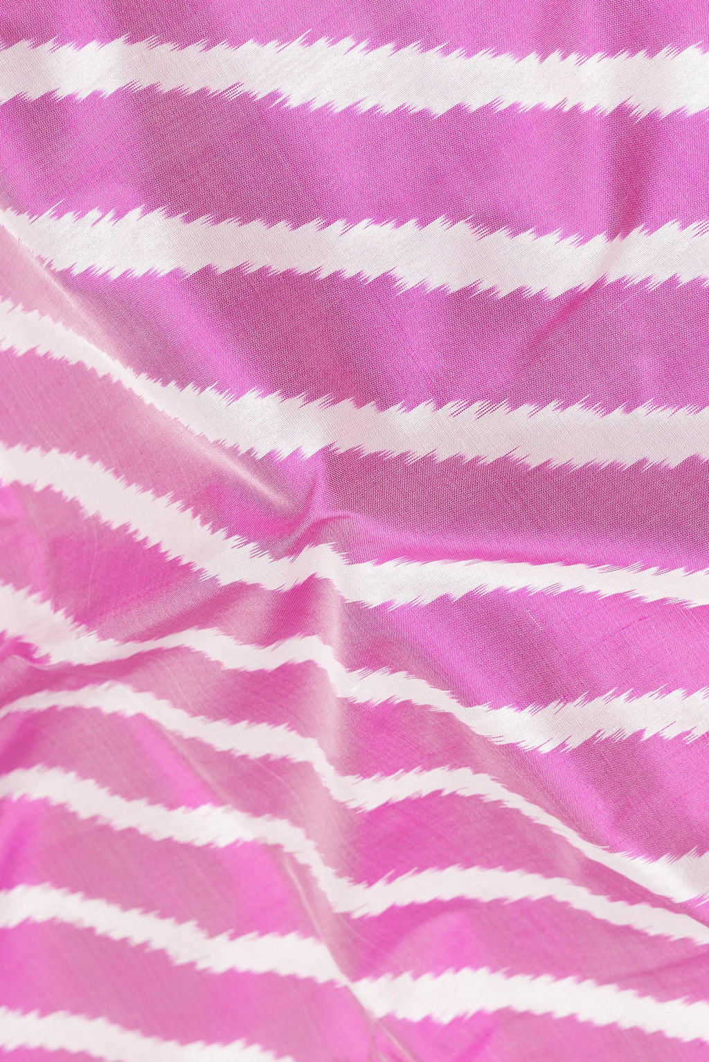 Close up of Pure Silk Pink Pochampally Saree with Ikat design on the body and Ikat Border.  displaying folds