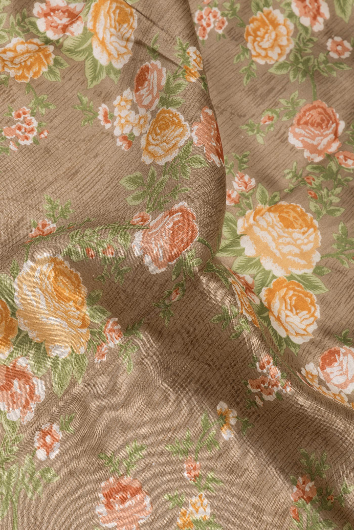 Close up of Dark Beige Chanderi Silk Saree with Printed design on the body and Fancy Border.  displaying folds