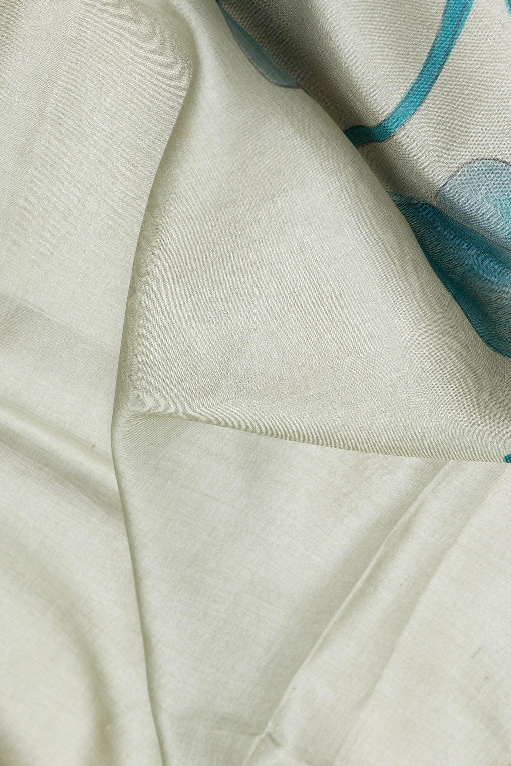 Close up of Light Green Tussar Silk Saree with Printed design on the body and Zari Border.  displaying folds