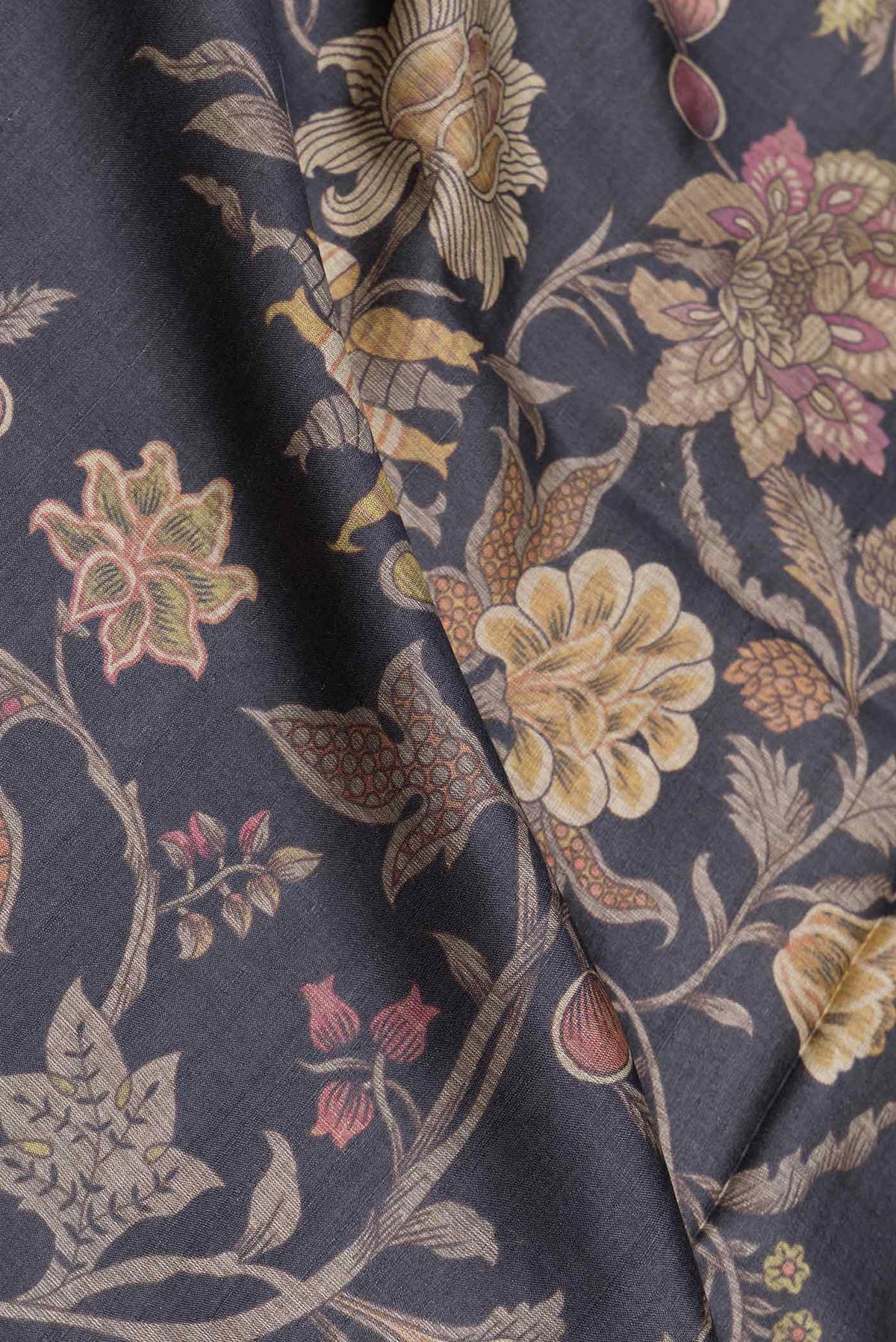 Close up of Black Dual Tone Tussar Saree with Printed design on the body and Embroidery Border displaying folds