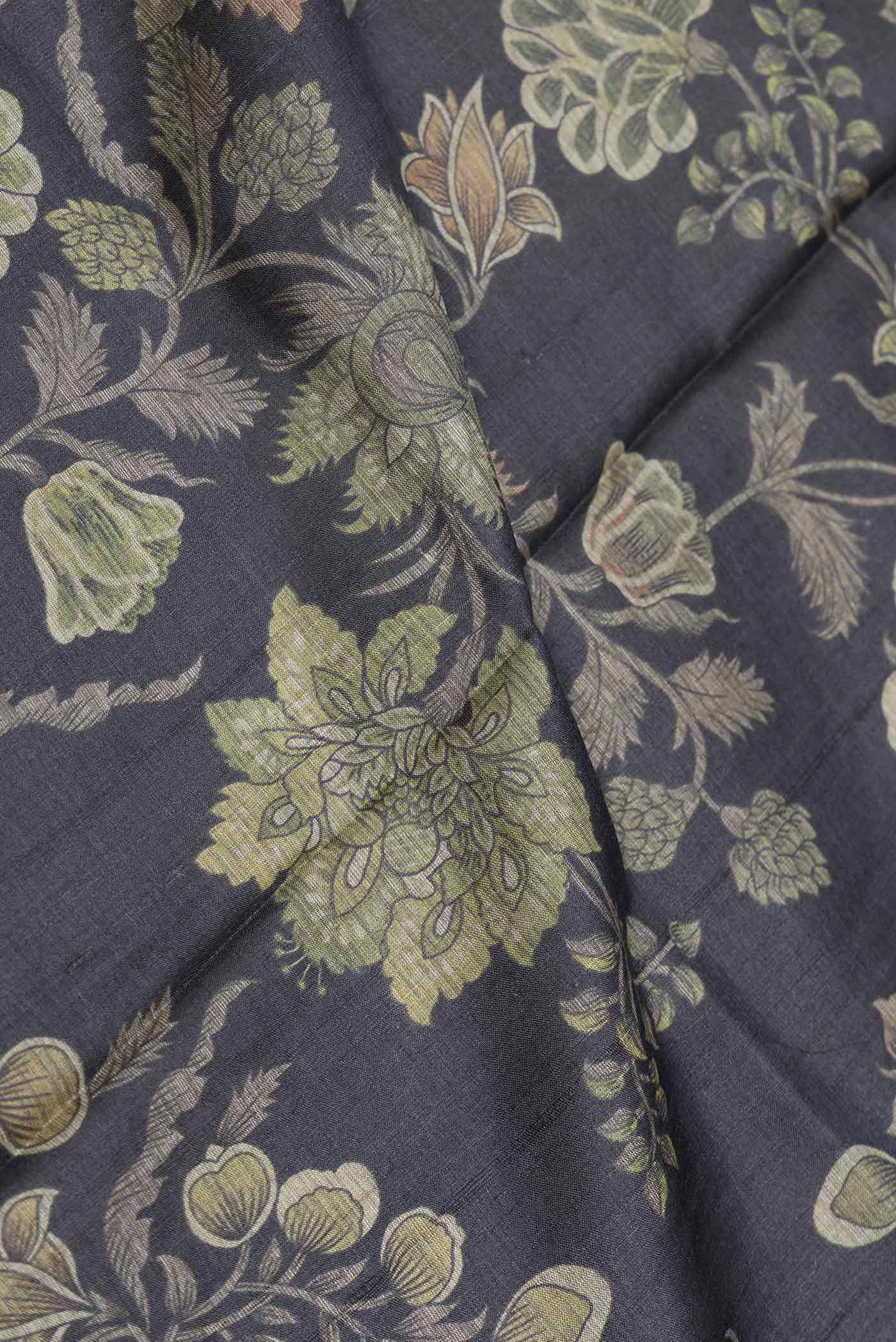 Close up of Black Dual Tone Tussar Saree with Printed design on the body and Embroidery Border displaying folds